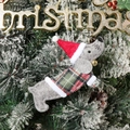 Detailed view of felt dachshund Christmas ornament wearing plaid sweater and Santa hat - Dachshund in Sweater / Gray