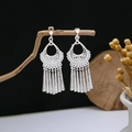 Ethnic silver-finish earrings featuring geometric hollow patterns and long metal tassels - E4958-1 (Vintage Carved Tassel)