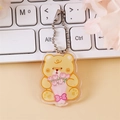 Cute yellow bear acrylic keychain with silver bead chain on white keyboard background - Flower Bouquet Bear