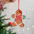 Gingerbread man Christmas ornament with red bow and candy accents, 12cm height - Gingerbread Man