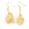 Close-up of handmade gold wire-wrapped raw yellow crystal agate drop earrings - Gold + Citrine