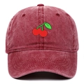 Close-up of cherry embroidery and vintage washed denim texture on a burgundy baseball cap - Burgundy