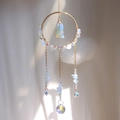 Golden suncatcher featuring an opal gemstone, faceted crystal ball, and star pendant detail - Opal