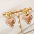 Minimalist double heart drop earrings in golden and beige finish on a T-shaped display stand - Double Heart Gold Rose Gold Stitching Earrings (KE111207-KFC)
