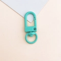 Detailed view of a mint green painted metal swivel clasp for DIY bags and keychains - Mint Blue