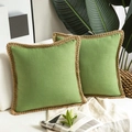 Detail of green linen pillow covers with braided jute trim on a beige sofa - Grass Green