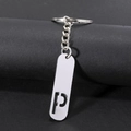 Polished silver metal keychain with cutout letter P pendant on a modern display - Letter P