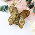 Elegant transparent butterfly hair claw clip in amber brown resin with hollow wing design - Jelly Green