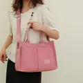 Pink felt tote bag with dual front pockets and adjustable strap for daily commute - Pink