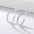 Close-up of S925 sterling silver C-shaped earrings with micro-set clear zircon stones - 925 Silver / Platinum Plated White Zircon