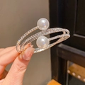 Macro shot of silver layered wrap bracelet with pavé rhinestones and two large pearls - 23# Bracelet - Silver