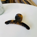 Macro shot of amber tortoiseshell resin hair claw clip with focus on spring detail - Glossy Light Tortoise