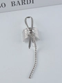 Macro shot of silver metal ear cuff featuring a knot design and long hanging chain detail - Silver