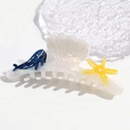Macro detail of iridescent shell-shaped acetate hair claw with whale and starfish decor - Whale Starfish Shell Claw