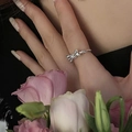 Minimalist silver twist ring featuring a bow knot design shown on model finger - Bowknot Shape Silver Open Ring (J2932)