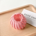 Pink bird nest hair clip with matte finish on a tray for ponytail styling - Glossy Pink