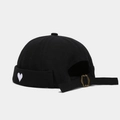 Detail of black cotton docker hat with white heart embroidery and bronze metal buckle - Black