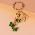 Gold butterfly keychain with three emerald green charms and crystal accents - Dark Green