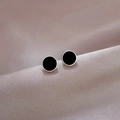 Macro shot of minimalist black round stud earrings on purple silk fabric background - Black and Silver Pair / Silver