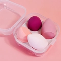 Top view of four colorful makeup sponges in a clear plastic egg box storage case - 4-Grid Strawberry Pink Box