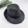 Detail of a black straw fedora hat featuring frayed edges and a matching ribbon band - M / Black