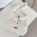 White faux shearling tote bag with drawstring closure and brown brand leather patch - White