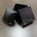 Detailed macro view of black faux leather watch box featuring luxury crocodile texture - Glossy Black Crocodile Pattern