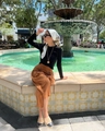 Detail of a white patterned satin silk scarf tied on a stylish lifestyle outfit - Paisley White