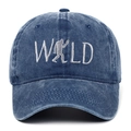 Detail of embroidered WILD logo with Bigfoot silhouette on washed blue baseball cap - Adjustable / Navy Blue