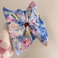 Floral silk scrunchie with pastel watercolor patterns on a woman's wrist - Lake Blue Watercolor Floral