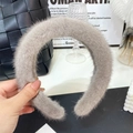 Grey faux mink fur headband with a soft plush texture held in a stylish indoor setting - Light Gray