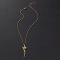 Detailed close-up of golden stainless steel flower pendant with cursive Arabic script - July Birth Flower (Larkspur) / Gold