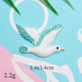 Detail of seagull resin charm with green wings for DIY hair clips and crafts - Blue Seagull Flying Right