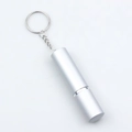 Close-up of a silver portable metal container with a keychain on a white background - White
