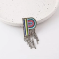 Close-up of letter R brooch with colorful embroidery, rhinestones and fringe tassels - Letter P