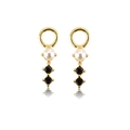 Detail of golden earring featuring a white pearl and two black gemstones with reflections - Model E [Pearl]