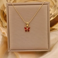Detailed close-up of a gold bead necklace featuring a dainty red zircon butterfly pendant - Gold + Red (Bead Chain)