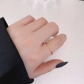 Minimalist gold titanium ring featuring five sparkling round-cut zircon stones - US 6 / Three Zirconia / Gold