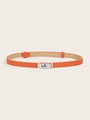 Close-up of orange lychee leather belt with a polished silver metal twist-lock buckle - (Silver Buckle) Cross Pattern Lock Adjustable Belt (Orange)