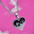 Detailed macro shot of silver heart pendant with black flame pattern on Cuban chain link - Black Flame Heart