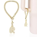 Golden iced-out bubble letter R charm with zircon stones on a gold Cuban chain - Letter R