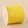 Spool of bright yellow 0.8mm nylon cord for handmade jewelry and DIY weaving projects - Gold