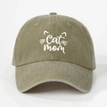 Close-up detail of Cat Mom embroidery on a green washed cotton baseball cap with fabric texture - Dark Khaki