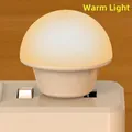 Portable warm light USB mushroom night lamp plugged into a white socket on wood background - Bare Unit / Y4 Warm Light