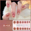 Close-up of CS-415 Christmas nail wraps with Santa and snowflake patterns in red and pink - CS415