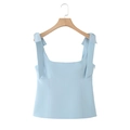 Sky blue sleeveless camisole top with decorative bow straps on a wooden hanger - XS / Light Blue