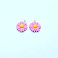 Detailed macro view of two pink daisy flower resin charms with silver metal rings - Lotus Pink