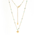 Détail d'un collier en acier inoxydable doré avec perles vertes et pendentif cœur - Perles Vert Printemps