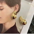 Macro detail of large gold teardrop earrings showing the polished mirror finish and drop shape - Gold Medium 3.1CM