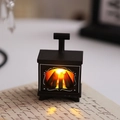 Close-up of mini LED fireplace lamp with warm orange glow on vintage paper background - Mini Fireplace / Black